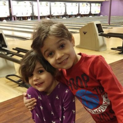 Two young kids bowling